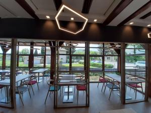 a restaurant with tables and chairs and windows at Motel Bajra in Travnik +14 photos