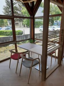 a table and chairs in a room with a window at Motel Bajra in Travnik