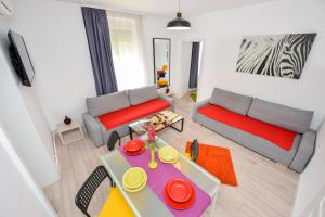 a living room with a couch and a table at Harmony Residence in Bucharest