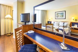 a hotel room with a bed and a large mirror at Holiday Inn Lisbon by IHG in Lisbon