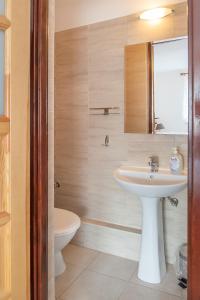 a bathroom with a sink and a toilet at Family Homes - Dom Wakacyjny EDA in Władysławowo