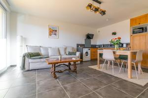 a living room with a couch and a table at Au 4 le long du canal avec Parking in Dijon