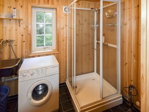 y baño con ducha y lavadora. en 5 person holiday home in Botnhamn, en Botnhamn