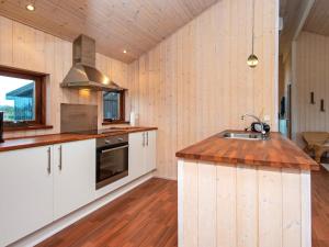 een keuken met witte kasten en een houten vloer bij 6 person holiday home in Tarm in Tarm