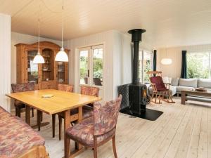 ein Wohnzimmer mit einem Tisch und einem Kamin in der Unterkunft 6 person holiday home in Thyholm in Thyholm