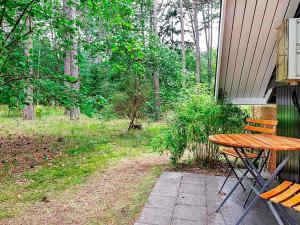 a picnic table and bench on the side of a house at 7 person holiday home in Store Fuglede in Store Fuglede