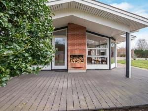 a house with a deck with a fireplace at 6 person holiday home in Silkeborg in Silkeborg