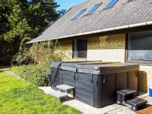 a house with a large hot tub in the yard at 14 person holiday home in Sj llands Odde in Tjørneholm