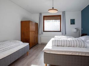 a bedroom with two beds and a window at 14 person holiday home in Sj llands Odde in Tjørneholm