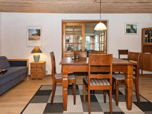 a dining room with a table and chairs at 6 person holiday home in R nde in Rønde