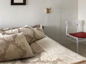 a couch with pillows and a chair in a room at Seaside Retreat in Lyngen-By Traum in Svensby