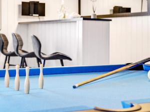 a row of bowling pins and bats on a court at 20 person holiday home in Stege in Stege