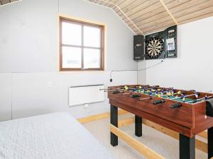 a room with a dart board on the wall and a dart board at 8 person holiday home in Harbo re in Harboør