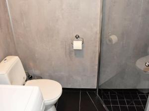 a bathroom with a white toilet and a shower at 10 person holiday home in Brattvåg in Brattvåg +47 photos
