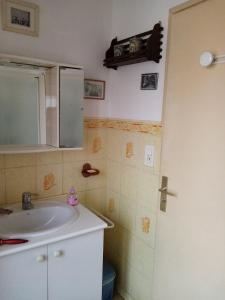 a bathroom with a sink and a mirror at Gîte au coeur de la Bretagne in Roudouallec +18 photos