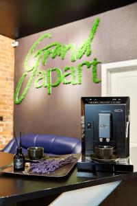 a coffee machine sitting on a table with two cups at GrandWhite Apart in Saint Petersburg