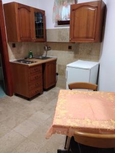 a kitchen with wooden cabinets and a table and a sink at Nonna Marija 1 in Rovinj +21 photos