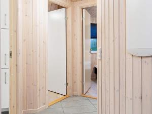 a bathroom with wooden walls and a sink and a mirror at 18 person holiday home in Hasselberg in Kappeln