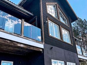 a black house with windows on the side of it at 8 person holiday home in VEMDALEN in Vemdalen