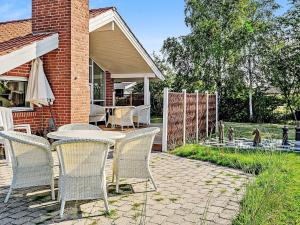 a patio with chairs and a table and a fence at 7 person holiday home in Kalundborg in Kalundborg