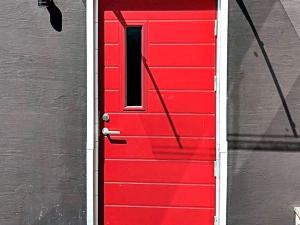 a red door with a window on a building at 8 person holiday home in VEMDALEN in Vemdalen