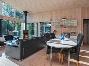 a dining room and living room with a table and chairs at 8 person holiday home in Glesborg in Glesborg