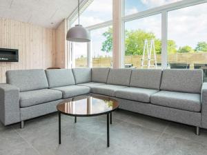 a living room with a couch and a coffee table at 16 person holiday home in Glesborg in Glesborg
