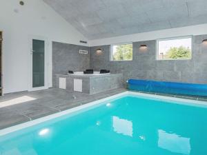 a large swimming pool with a tub in a room at 16 person holiday home in Glesborg in Glesborg