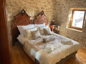 a bedroom with a large bed with two wooden headboards at Castle Inn in Kaštela