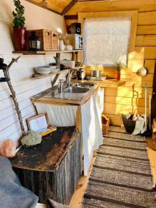 a kitchen with a sink in a cabin at Romantic Cabin right on the lake with fire place in Stjärnsund