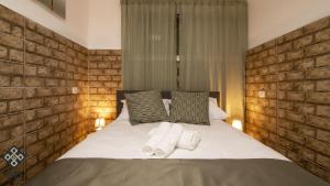 a bedroom with a bed with towels on it at Aida Guest house in Nazareth