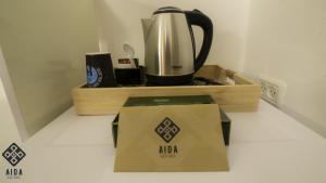 a coffee pot and a box on a counter at Aida Guest house in Nazareth