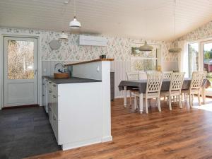 a kitchen and dining room with a table and chairs at 8 person holiday home in Silkeborg in Silkeborg