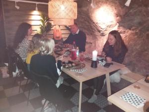 a group of people sitting at a table in a restaurant at Charming 1-Bed Apartment in Lulea in Luleå