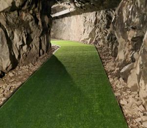 a tunnel with green grass in a stone wall at Charming 1-Bed Apartment in Lulea in Luleå