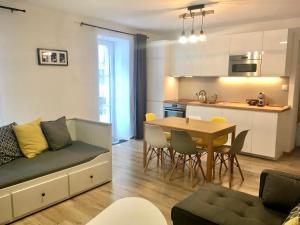 a living room and kitchen with a couch and a table at Apartman u Štoly in Jáchymov