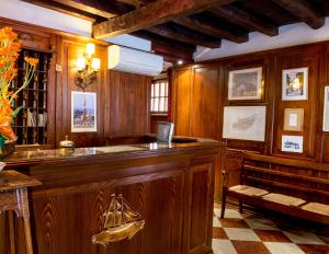 a large wooden bar with a bench in a room at Hotel Agli Alboretti in Venice