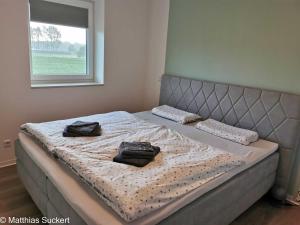 1 dormitorio con 1 cama con 2 almohadas en Fewo Captain Hook Haus Norderney, en Hooksiel