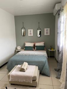 a bedroom with a large bed and a table at T3 moderne au cœur du village in Ouangani