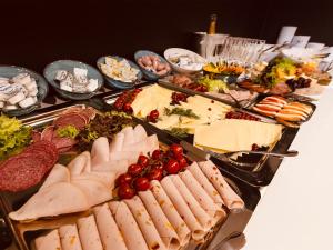 a buffet of meats and cheese and other foods at DORMERO Hotel Hof in Hof