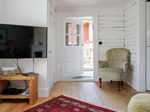 a living room with a chair and a television at 4 person holiday home in Mellösa in Mellösa