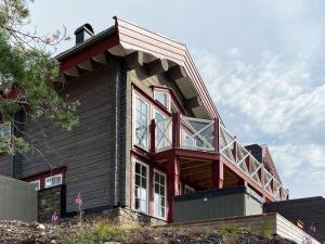 a house with a balcony on top of it at 8 person holiday home in S LEN in Sälen