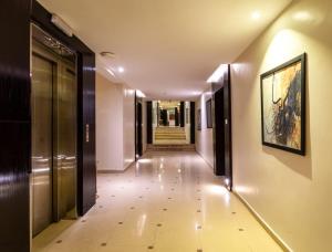 a hallway in a building with a painting on the wall at Al Muhaidb Al Olaya - Khurais in Riyadh