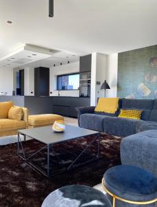 a living room with two couches and a table at Le Clos du Verger in Aubel