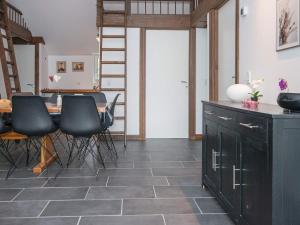 a room with a table and chairs and a staircase at 6 person holiday home in Ansager in Ansager