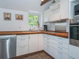 een keuken met witte kasten en een wastafel bij 6 person holiday home in Ansager in Ansager