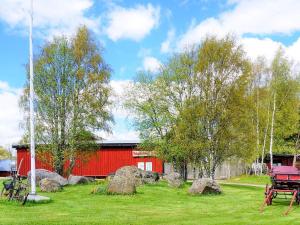 a red barn with a picnic table in the grass at 4 person holiday home in SANDHEM in Sandhem