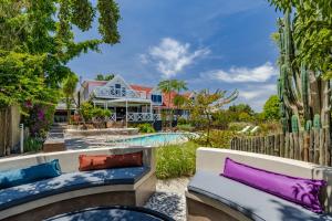 a patio with couches and a pool in front of a house at YEBO Boutique Guesthouse in Somerset West