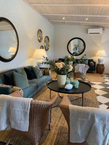 a living room with a couch and a table at Stegeborg Trädgårdshotell in Stegeborg