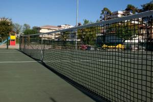 a tennis net on a tennis court at Hotel Falcone in Lignano Sabbiadoro
